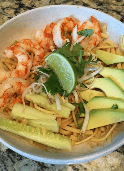 An Asian noodle bowl recipe featuring succulent shrimp combined with creamy avocado and zesty lime.