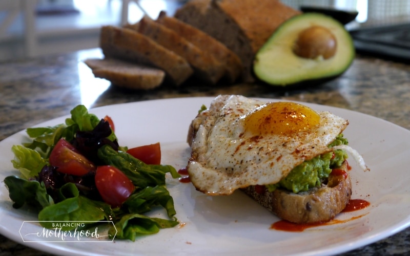 Avocado toast with egg and a side salad