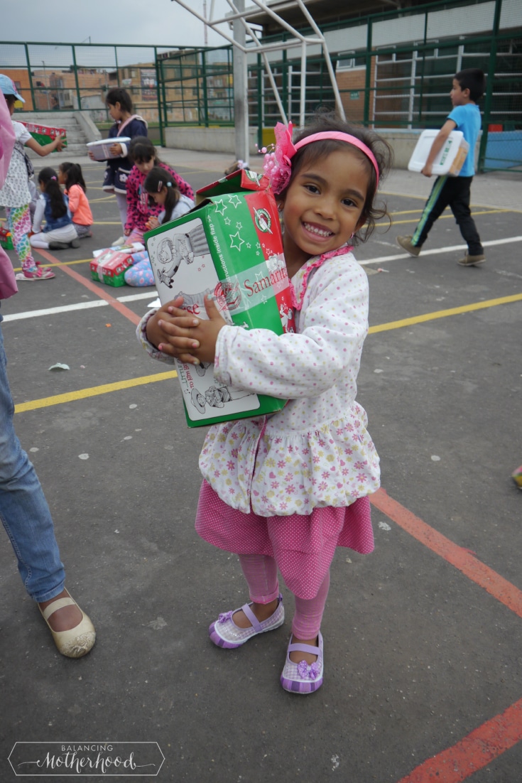 Little girl hugging her gift