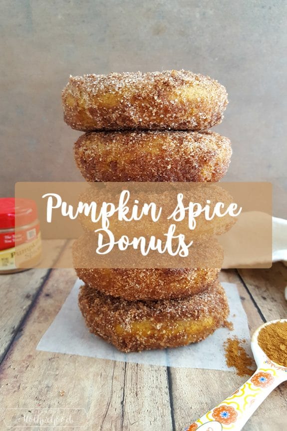 pumpkin donuts stacked on top of table