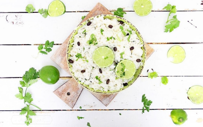 bowl with jasmine rice and limes on cutting board