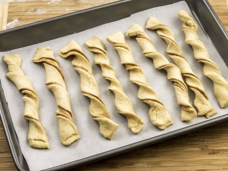 twisted pastry on baking sheet