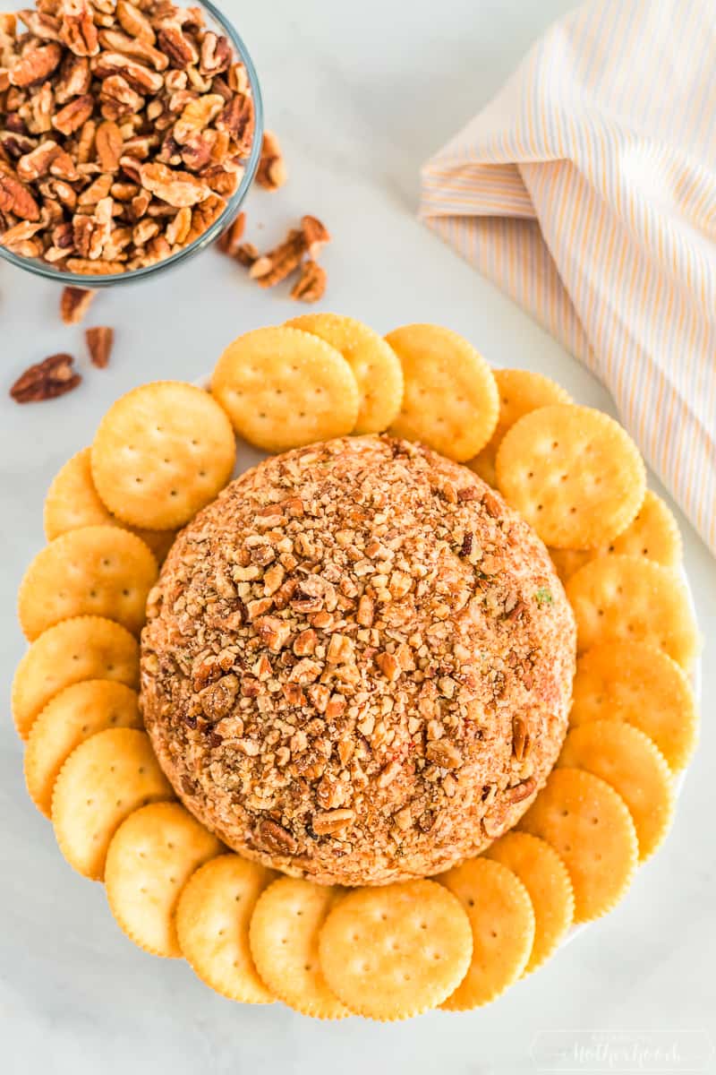 finished pineapple cheeseball with crushed pecans and Ritz crackers