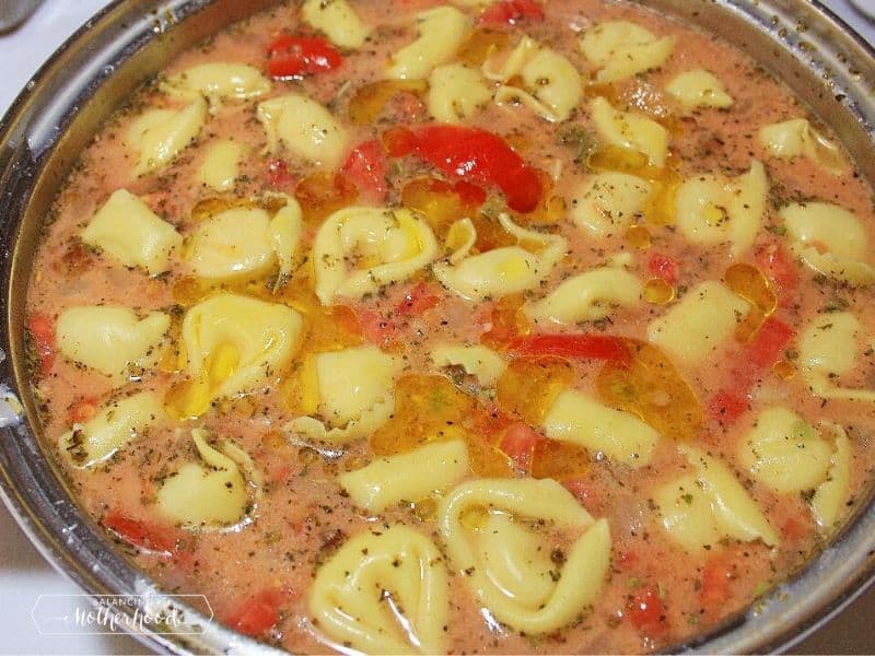 pot of tortellini soup with tomatoes