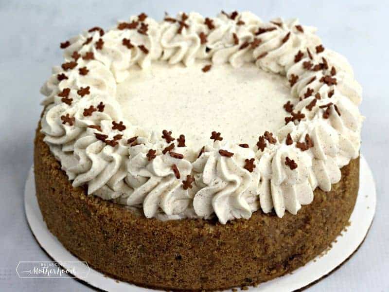 gingerbread cheesecake with piped frosting and mini gingerbread sprinkles