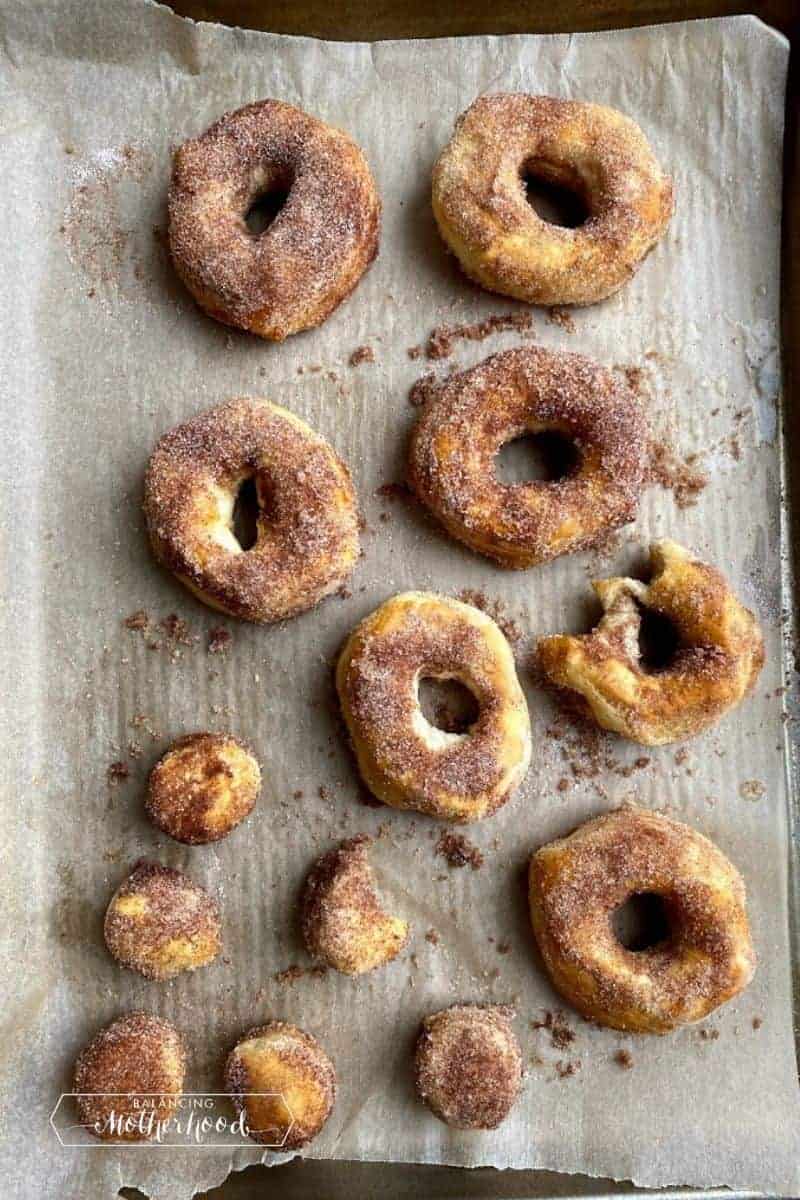 top down view of cinnamon sugar donuts on parchment paper