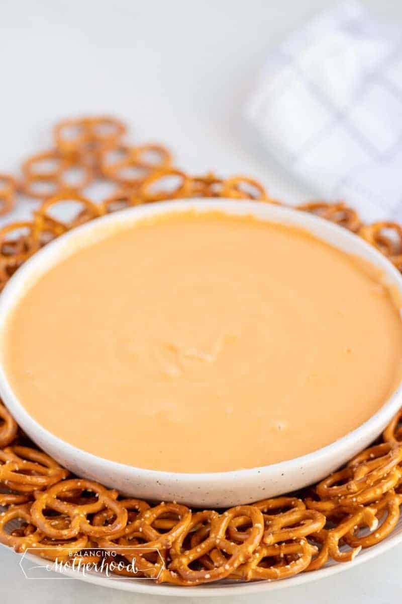 cheese dip in bowl surrounded by hard pretzels