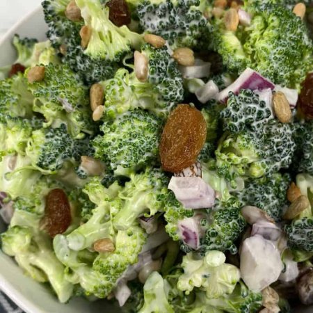 large bowl of broccoli salad on linen napkin