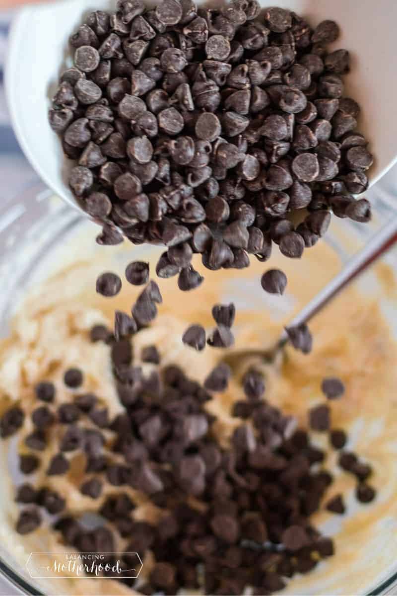 chocolate chips pouring into batter