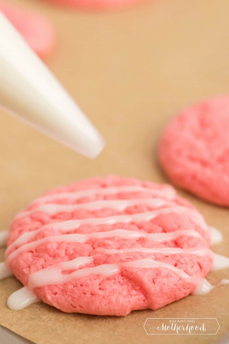 frosting drizzle on pink cake mix cookies