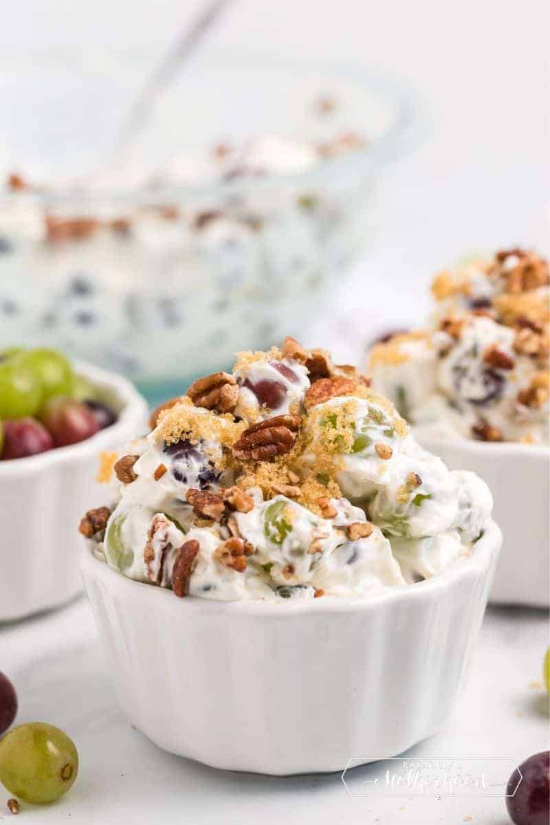 bowls of grape salad with nuts on top