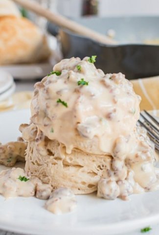 two biscuits stacked with sausage gravy on top