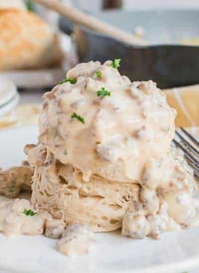 two biscuits stacked with sausage gravy on top