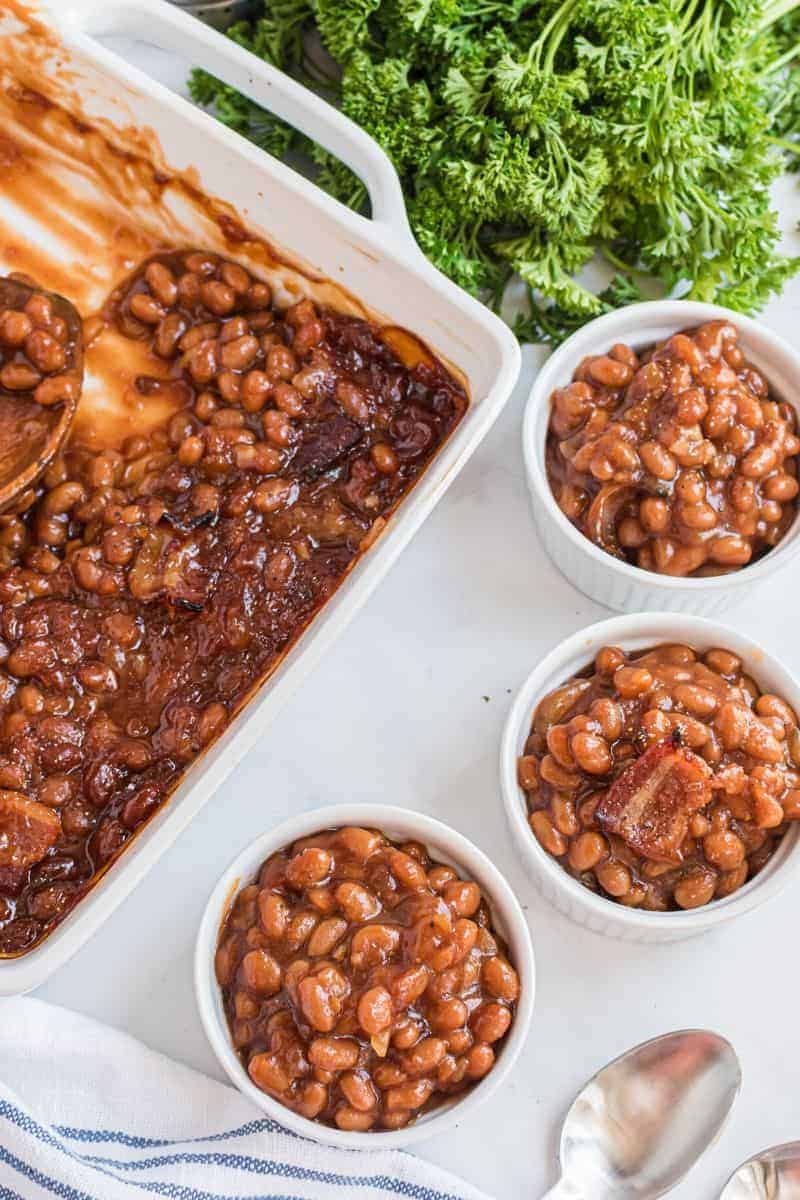 casserole dish with servings of baked beans next to it