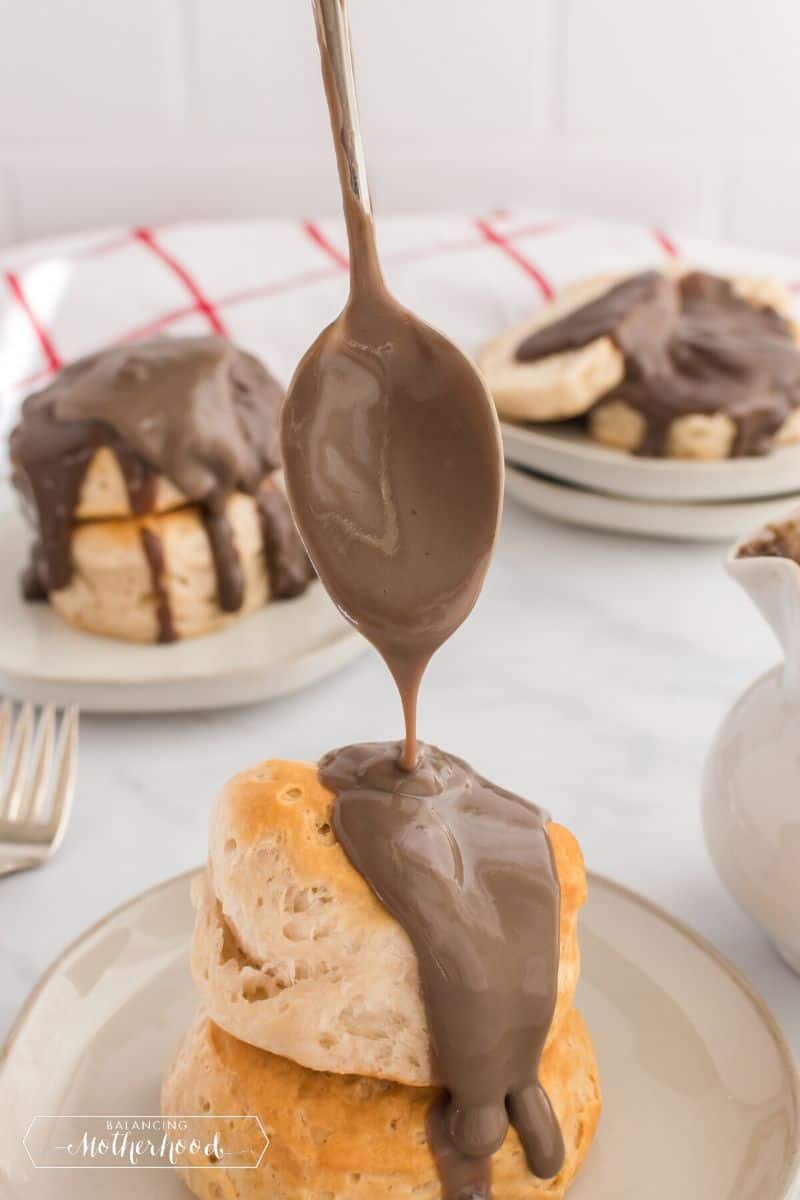 biscuits with chocolate gravy being drizzled on top