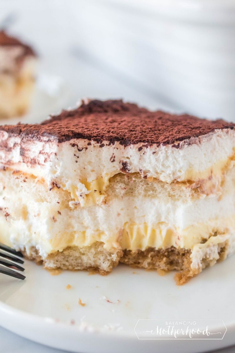 slice of tiramisu on plate with bite out of it