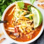 close up of tortilla soup with slice of lime