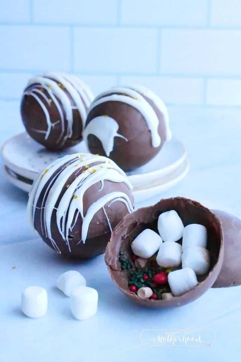 How chocolate bombs. One is left open to show marshmallows and sprinkles inside. 