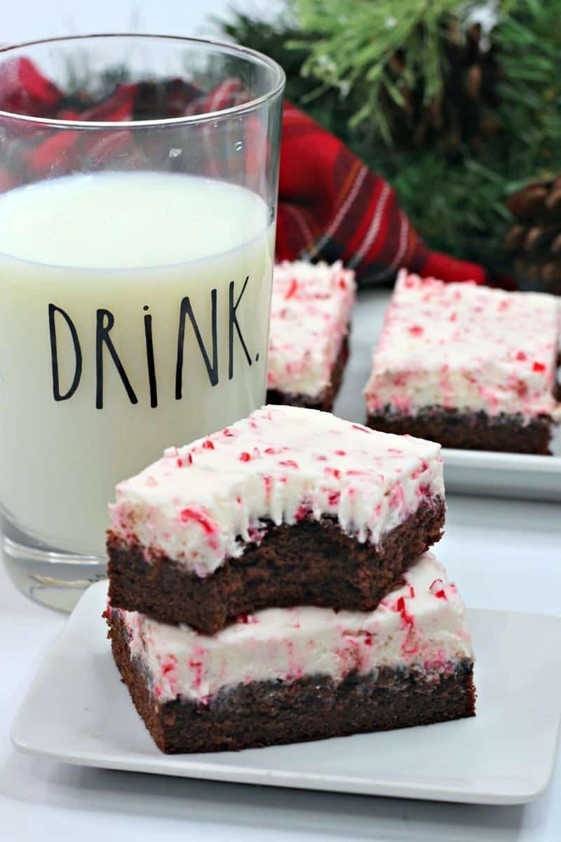 two brownies stacked on top of each other with a glass of milk