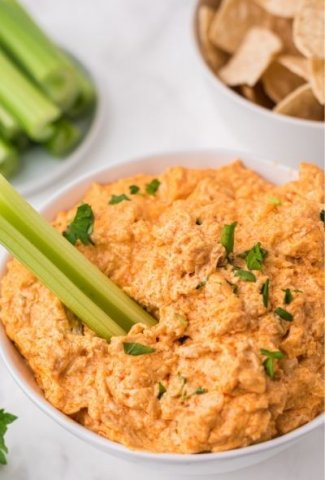 chicken dip in bowl with celery