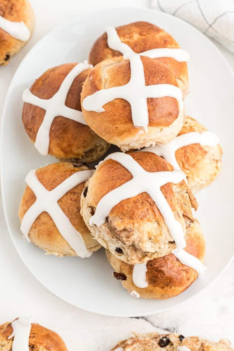 plate of warm hot cross buns with frosting