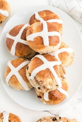 hot cross buns stacked on white plate