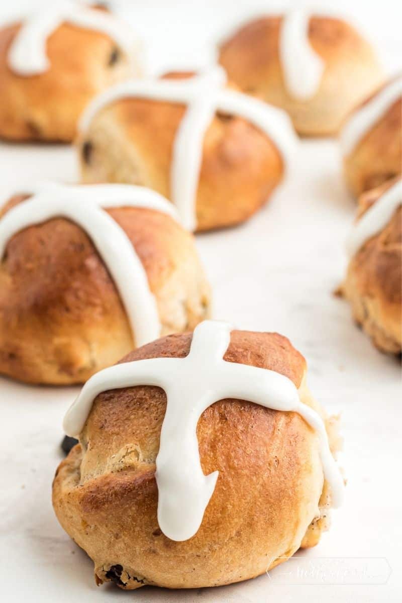 hot cross buns on table with thick white icing crosses on top