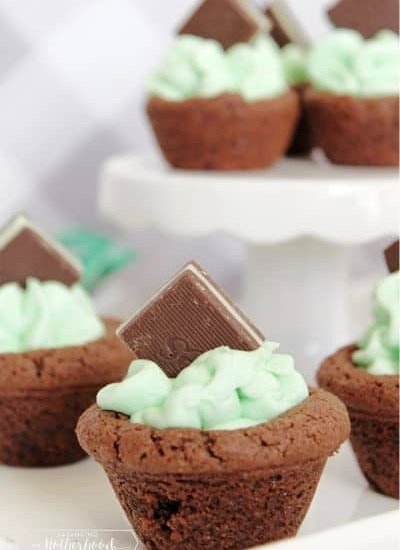 chocolate cookie cup with green buttercream frosting and Andes mint