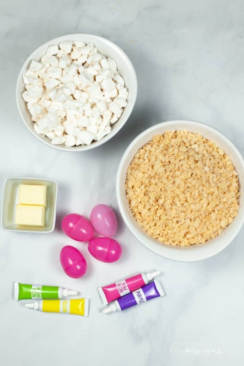 rice crispy treat Easter egg ingredients: mini marshmallows, crispy treat cereal, butter, plastic eggs, and food coloring