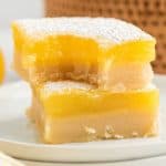 two lemon bars stacked, top one has a bit out