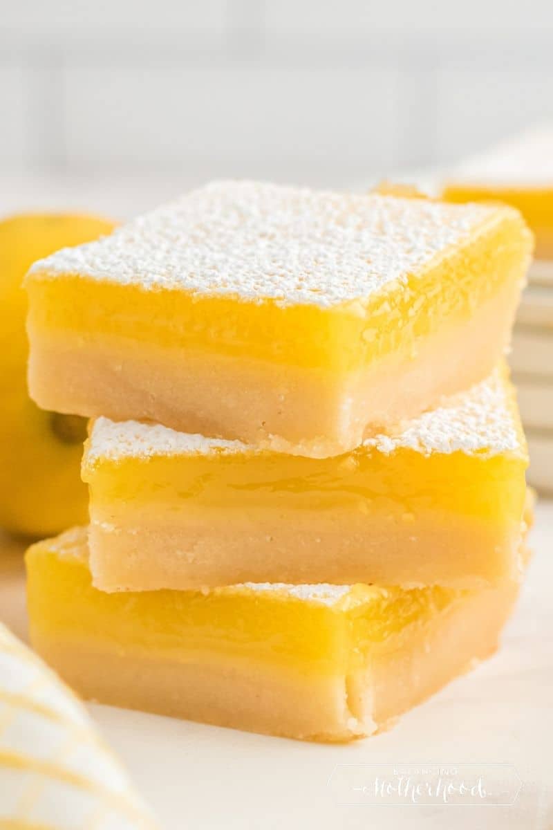 three square lemon bars stacked on top of each other