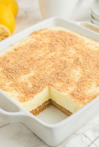 cheesecake in white baking dish with one slice removed