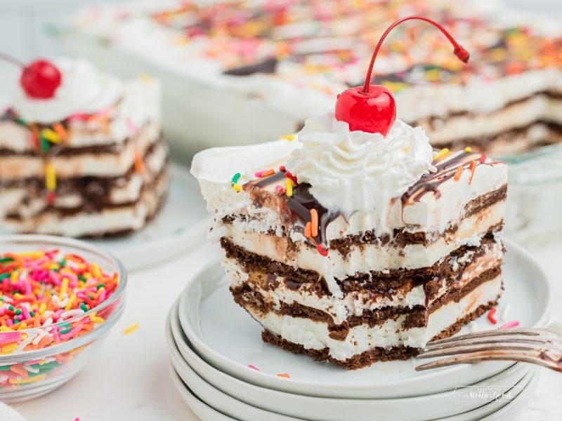 slice of ice cream sandwich sandwich cake with whipped cream and a cherry