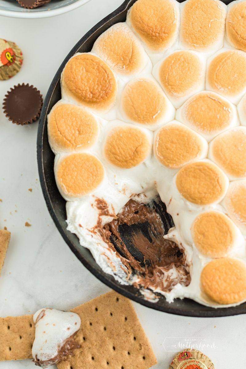skillet with golden marshmallows and melted chocolate