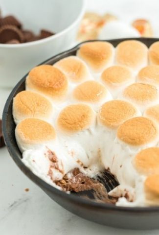 skillet with golden marshmallows and melted chocolate