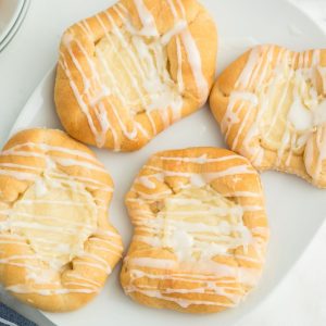 four danishes on white plate
