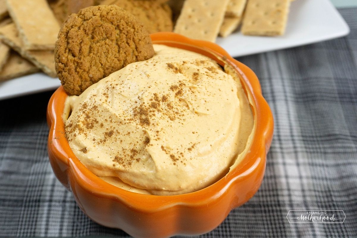 orange bowl with fluffy pumpkin pie dip and gingersnap