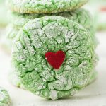 green crinkle cookie with red heart in the middle