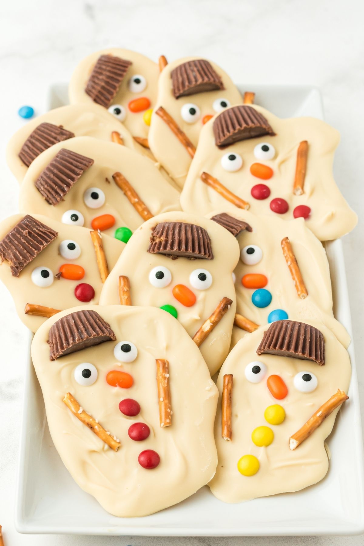 white chocolate bark with pretzel sticks, and sprinkles that look like a melted snowman