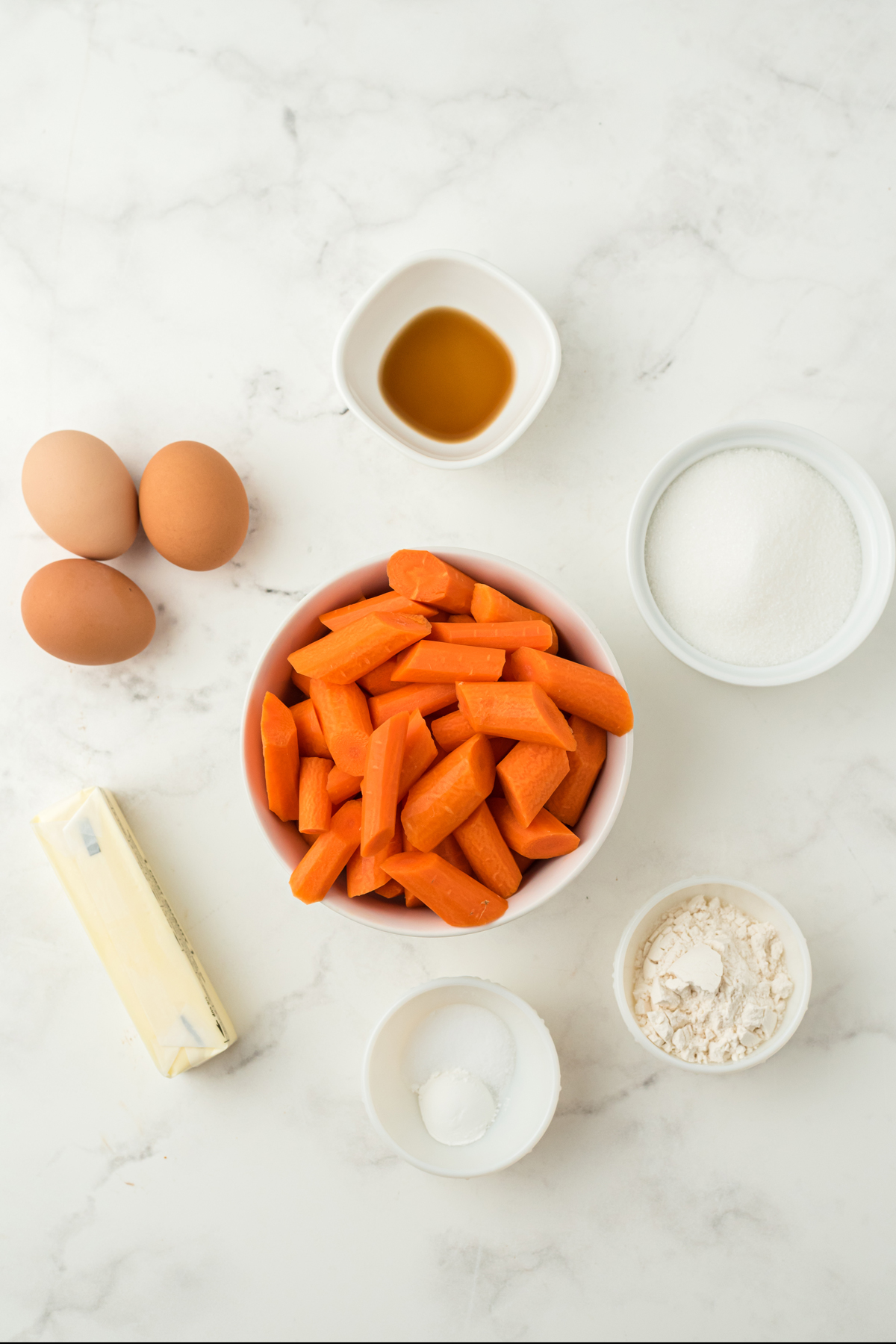 Ingredients of Carrot Souffle Recipe includes 1lb carrots, 1 stick butter, 3 eggs, sugar, flour, baking powder, vanilla, and salt.