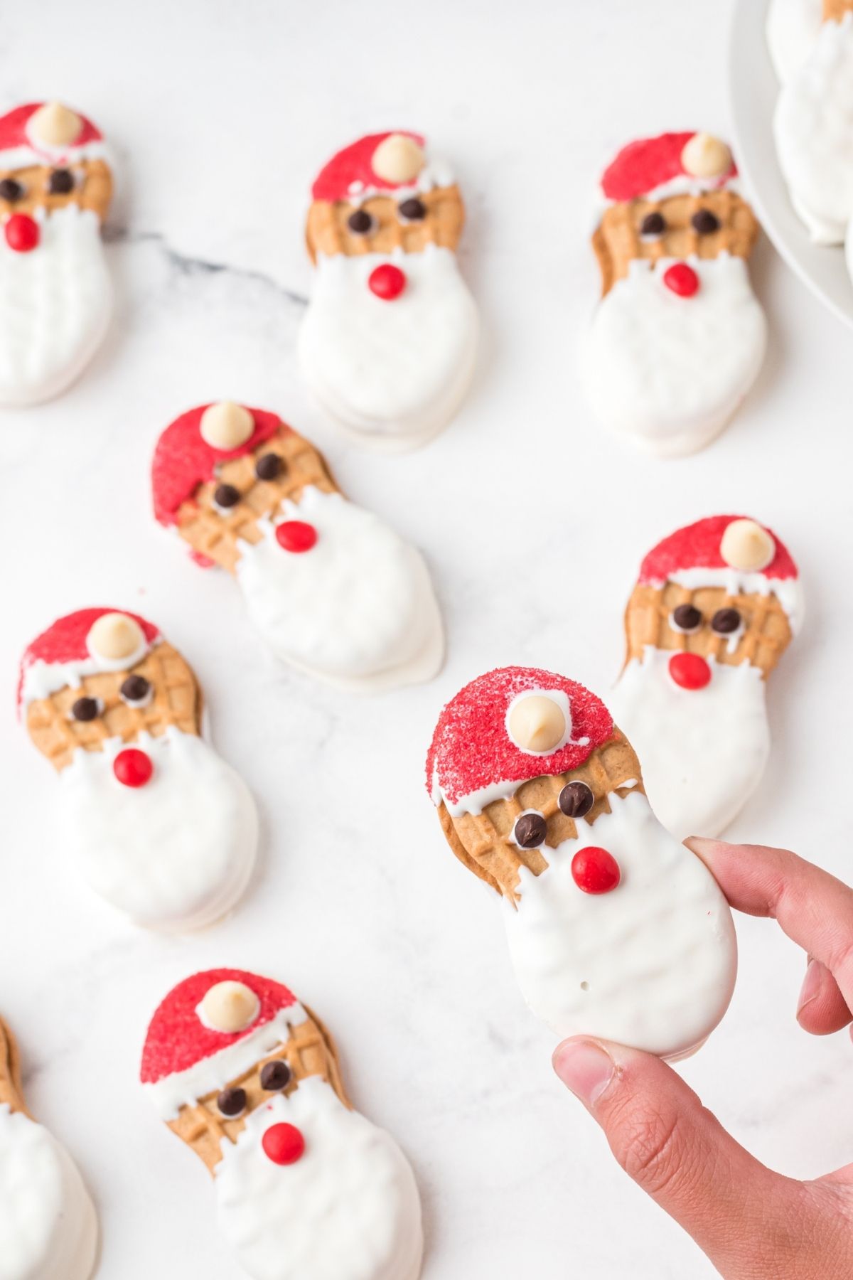Nutter butter cookies with red sprinkles for a hat and a white chocolate beard