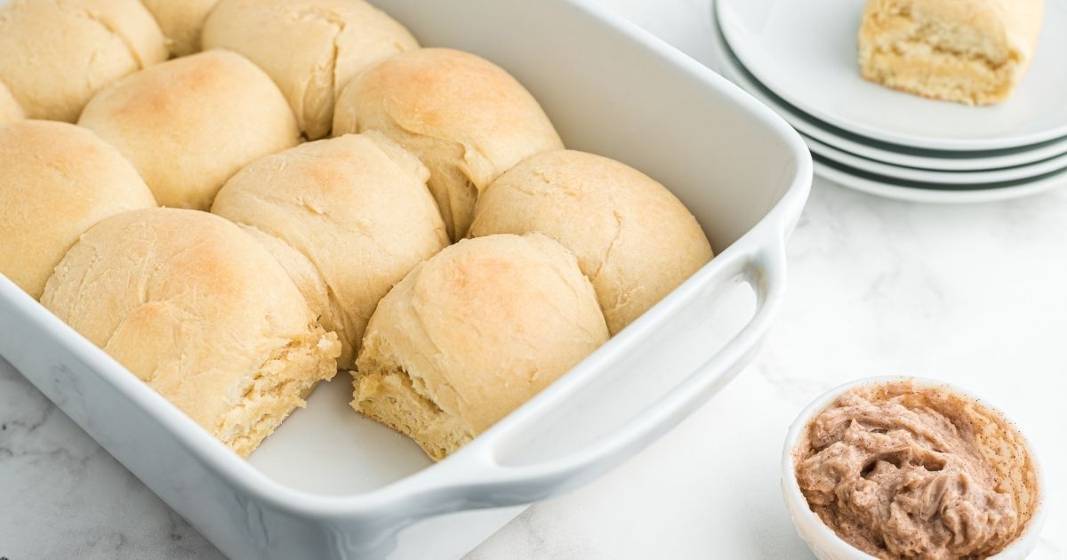 baked rolls in casserole dish with cinnamon butter on the side