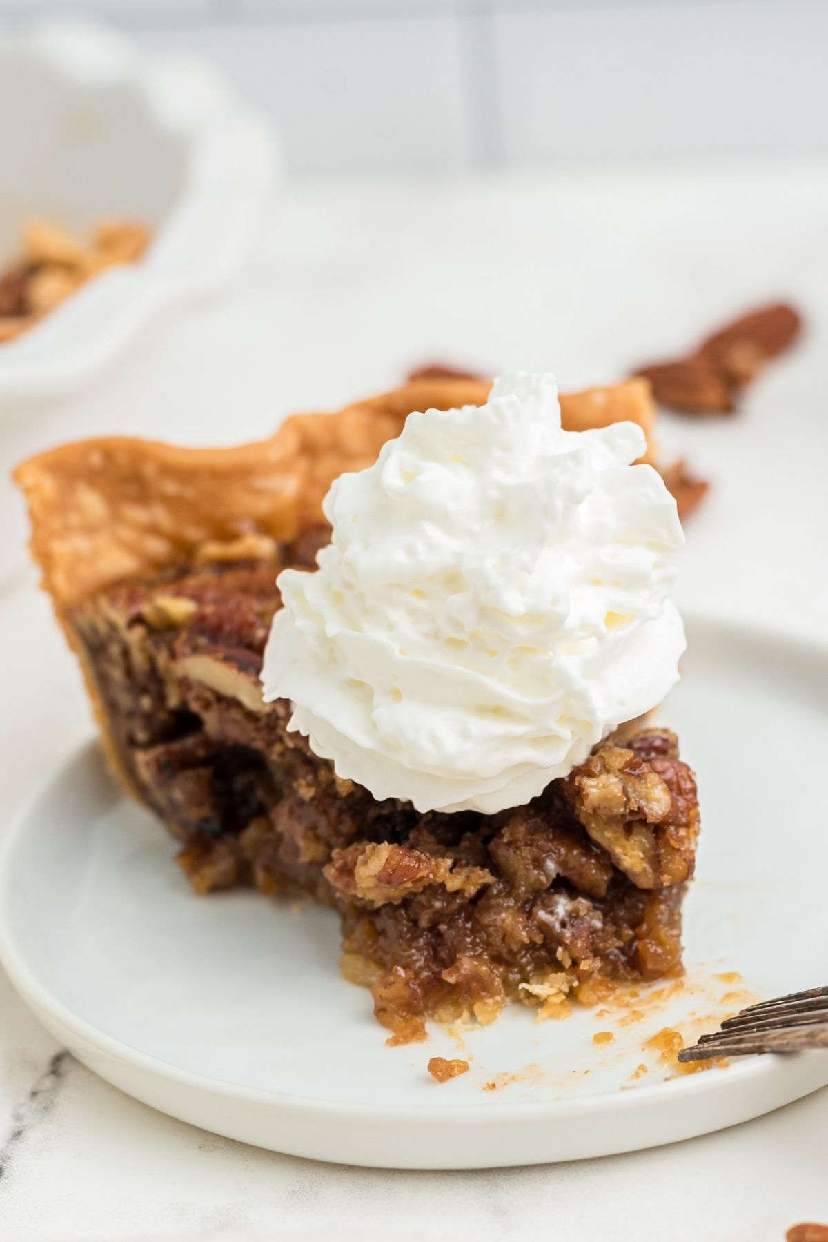 slice of pecan pie with whipped cream on top