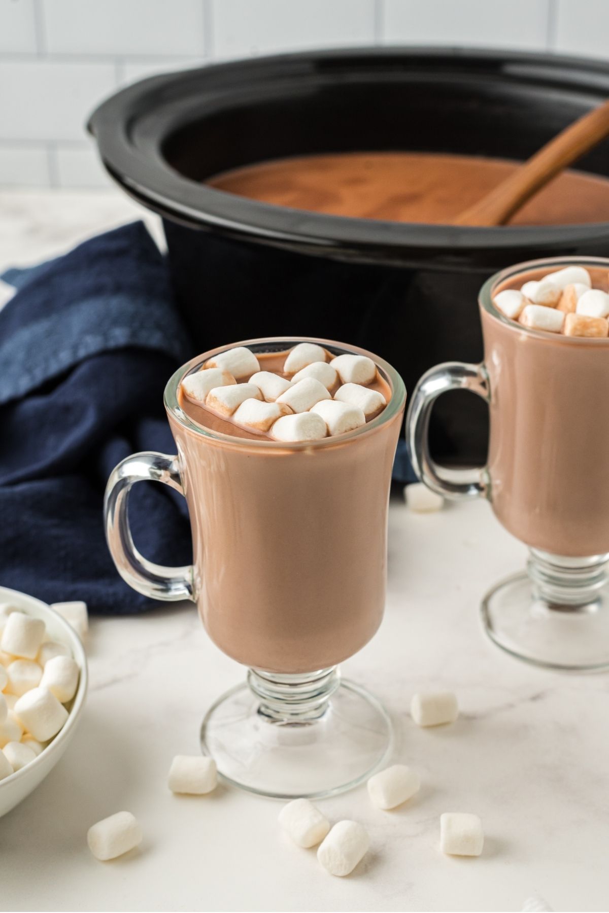 two clear mugs with hot chocolate and mini marshmallows
