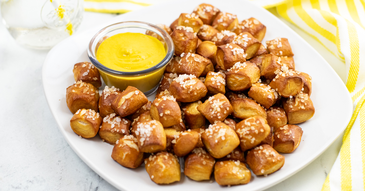 pretzel bites with mustard sauce on white plate