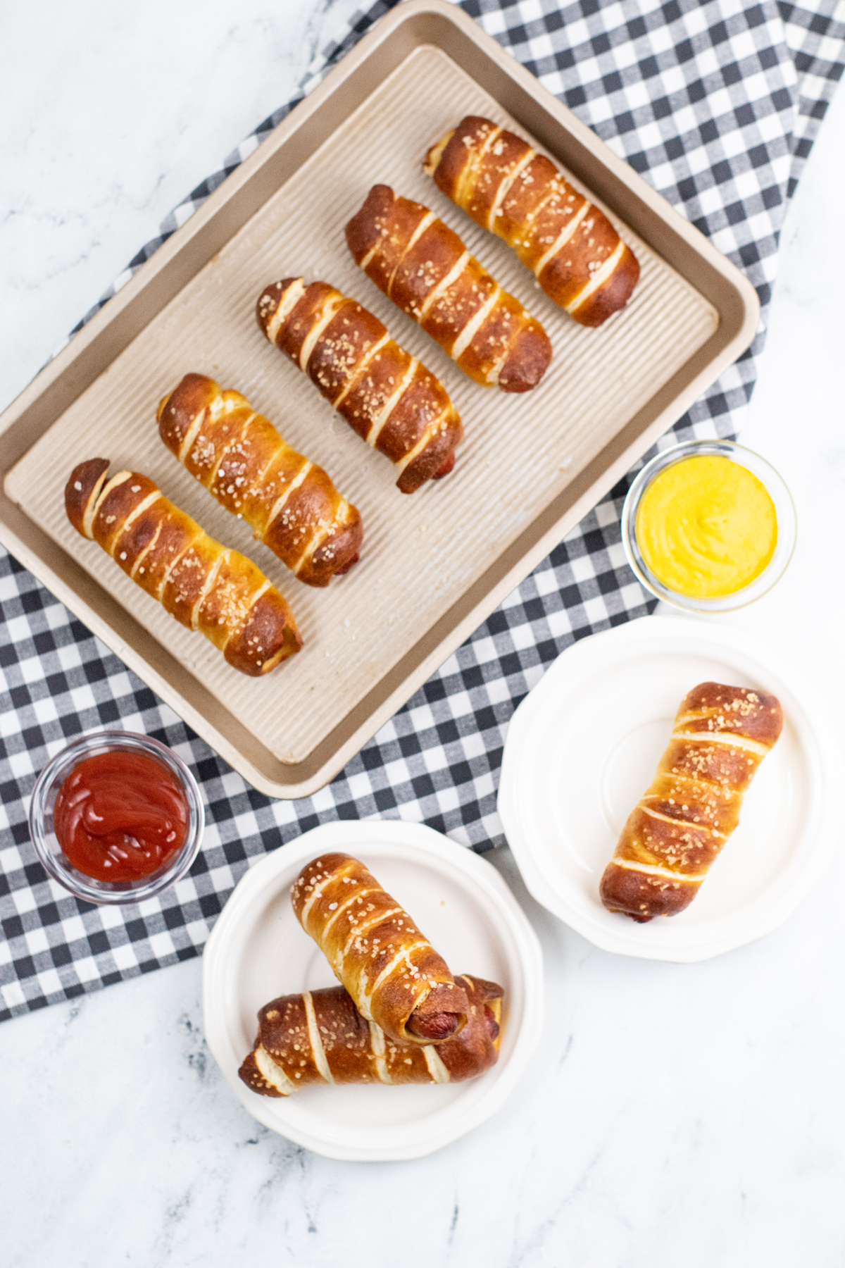 hot dogs wrapped in pretzel baked on baking sheet 