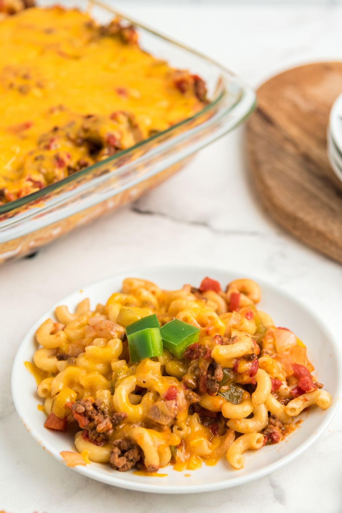 macaroni cheese burger casserole on white plate with ground beef and peppers