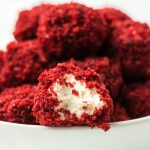 red velvet cheesecake balls with a bite taken