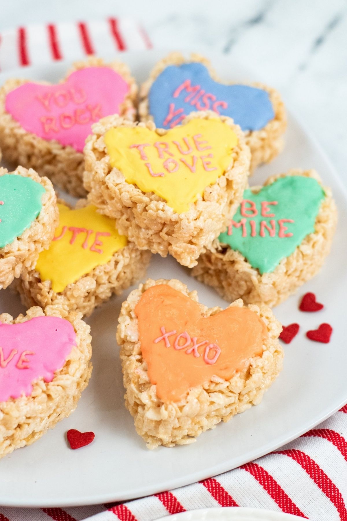 heart-shaped rice krispie treats with colorful frosting and words