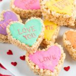 blue, pink, and yellow heart-shaped krispie treats on plate